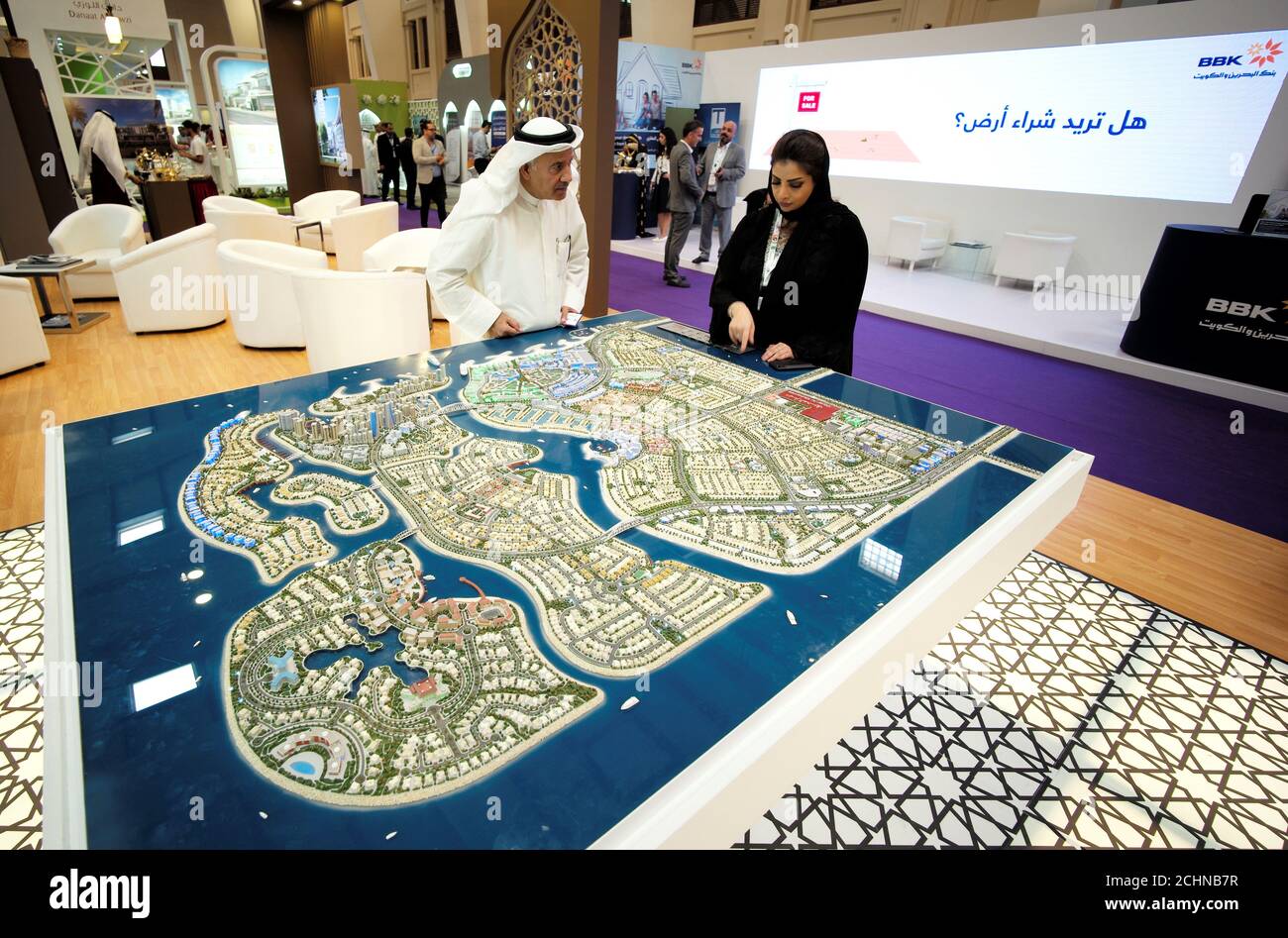 Visitors look at the mockup of a project at the Gulf Property, Construction and Interior Exhibition in Manama, Bahrain April 26, 2017. REUTERS/Hamad I Mohammed Stock Photo