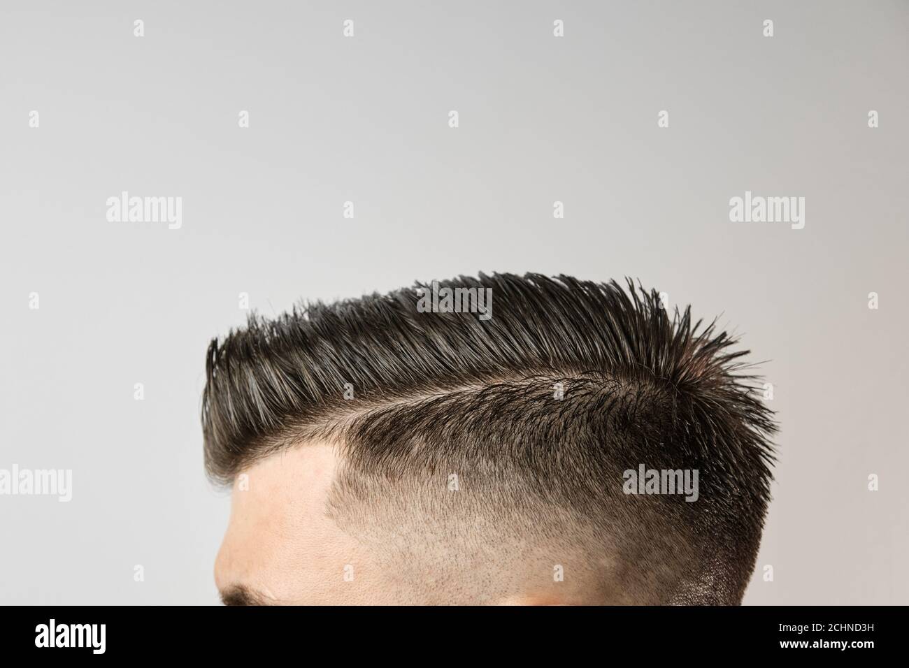 Perfect styling of hair after barbershop on the grey background. Hair loss treatment concept. Mens cosmetic products concept Stock Photo - Alamy Perfect styling of hair after barbershop on the grey background. Hair loss treatment concept. Mens cosmetic products concept Stock Photo - Alamy