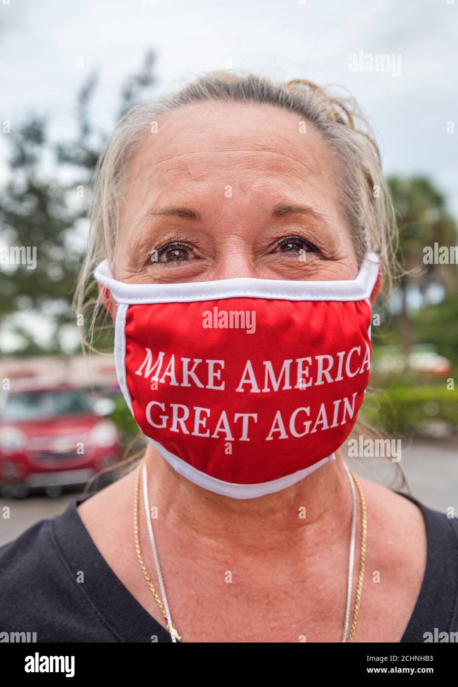 Woman wearing a MAGA mask during the Covid 19 Pandemic in Florida, getting ready to go shopping. Stock Photo