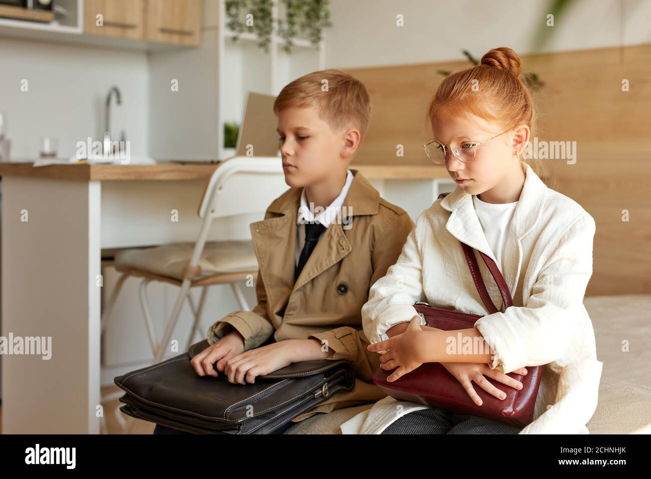 tired kids couple waiting for their taxi in hotel, want to sleep, sad