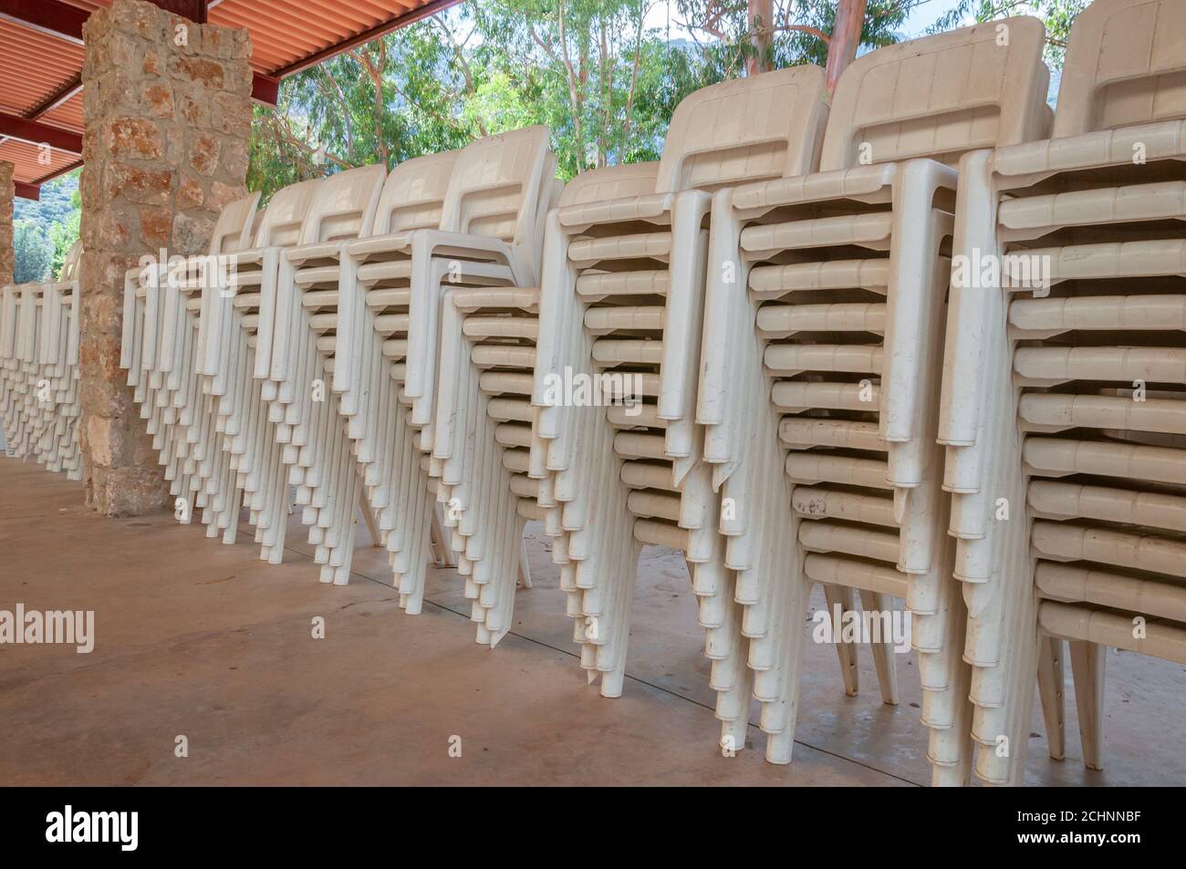 White plastic sallies stacked in a row inside a shed. Conceptual image Stock Photo