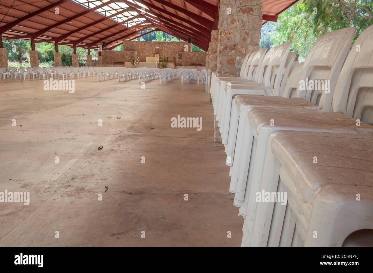 White plastic sallies stacked in a row inside a shed. Conceptual image Stock Photo