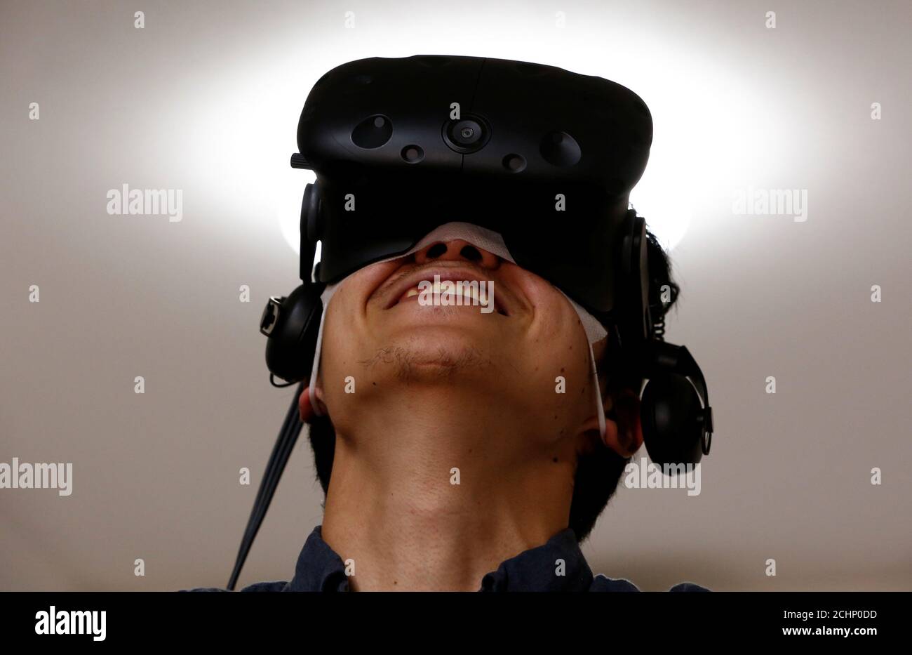 A Virtual Reality gamer reacts as he demonstrates VR JCC's virtual reality  adult game "Let's Play with Nanai!" with VR headset at the company's SOHO  office in Tokyo, Japan, June 13, 2017.