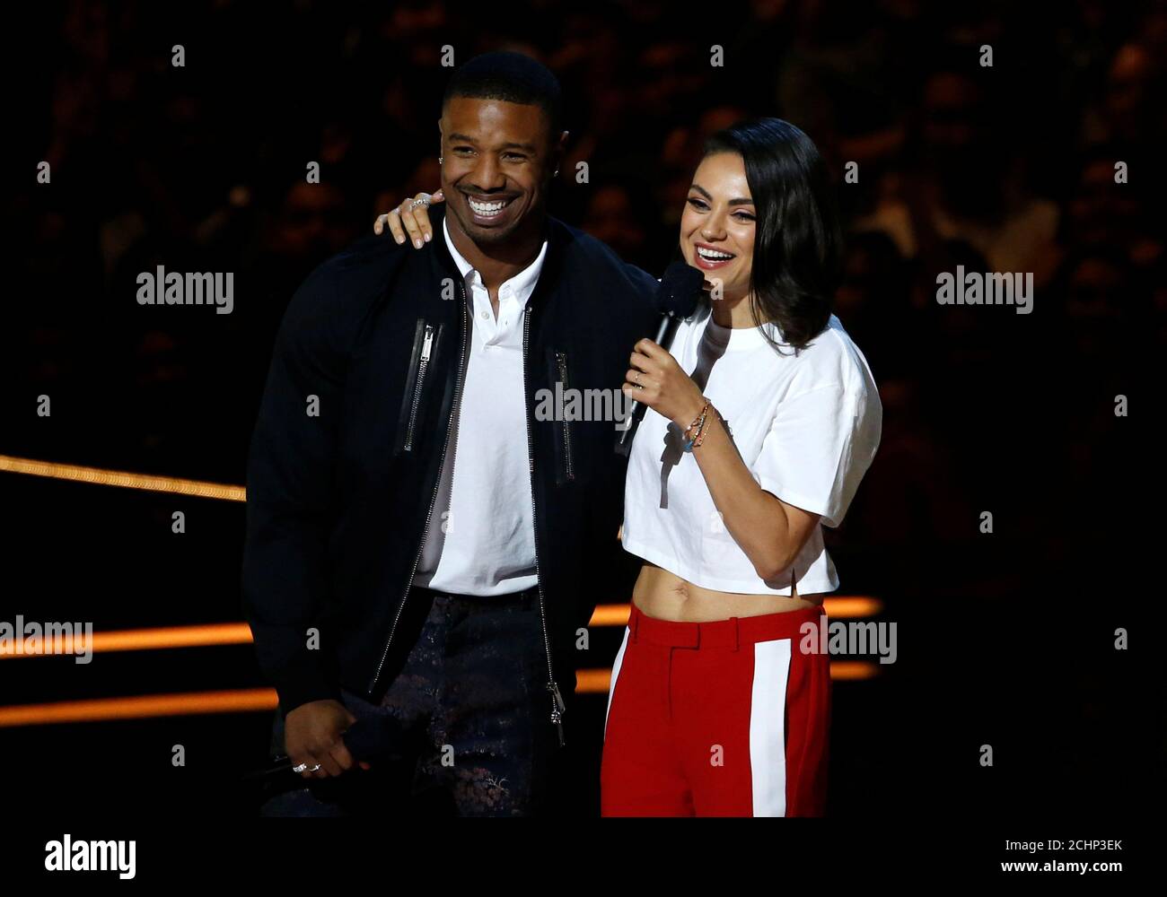 Actors Michael B. Jordan and Mila Kunis speak at the 2018 MTV Movie & TV  Awards