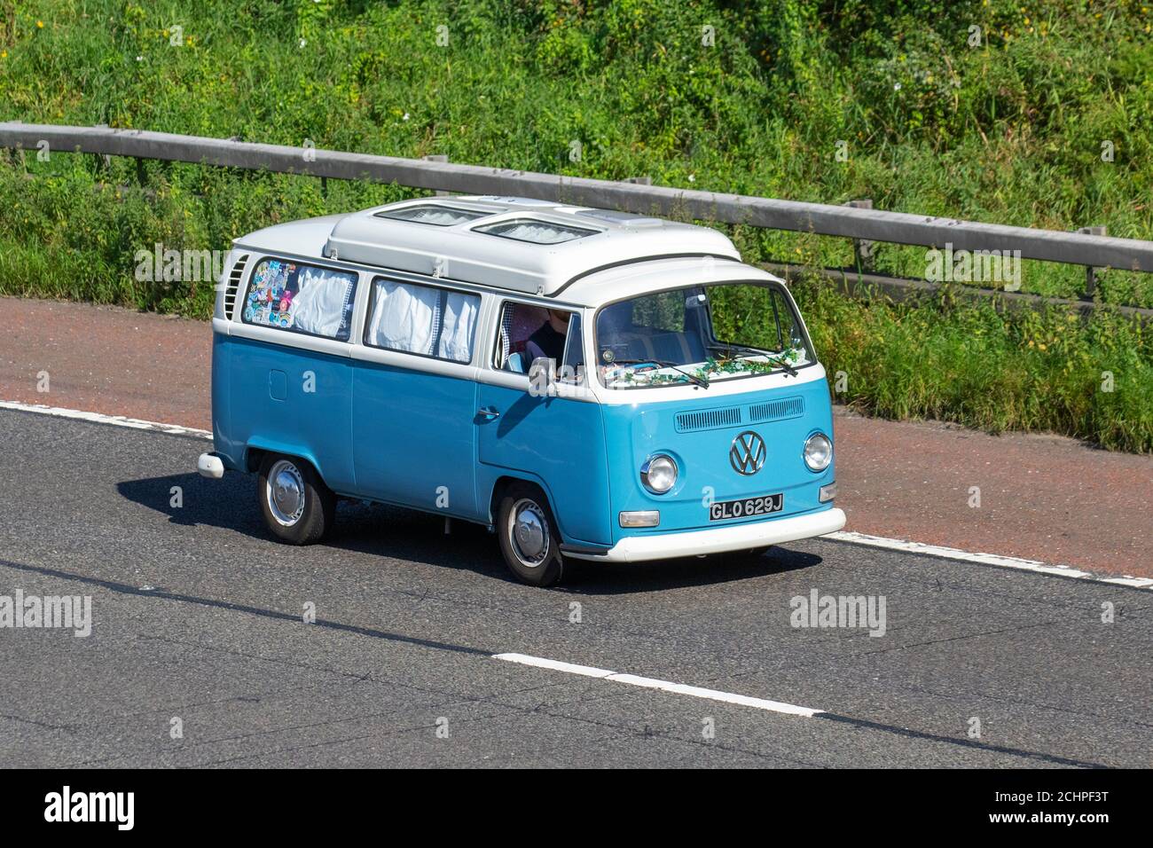 1971 70s blue white Kombi, VW Volkswagen Caravans and Motorhomes, campervans on Britain's roads, RV leisure vehicle, family holidays, caravanette vacations, Touring caravan holiday, van conversions, Vanagon autohome, life on the road, Bay Window Dormobile Stock Photo