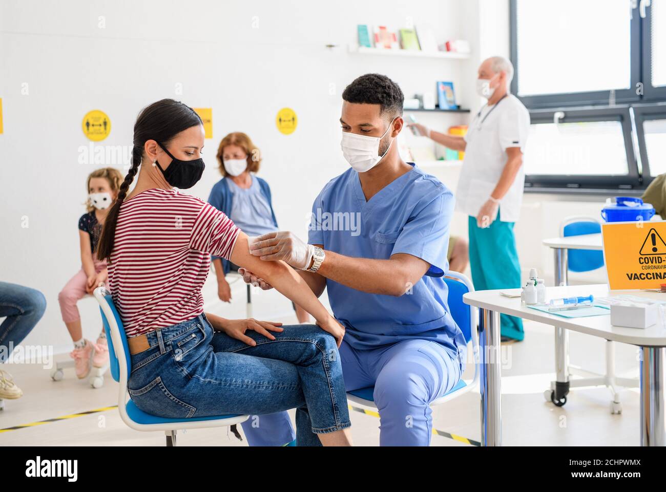 Woman with face mask getting vaccinated, coronavirus, covid-19 and vaccination concept. Stock Photo