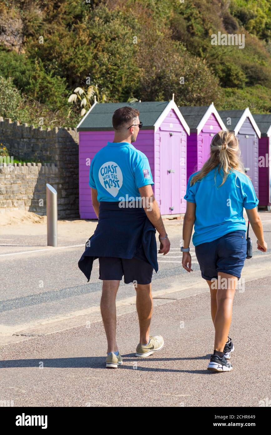 Dorset Ranger BCP council rangers walking along promenade past beach huts at ...