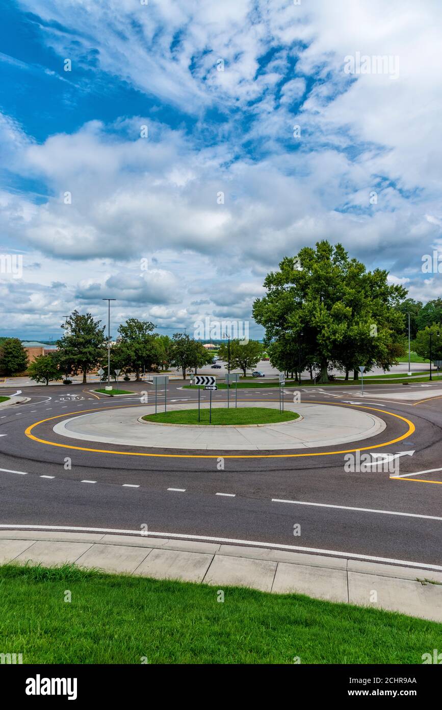 Vertical shot of a traffic roundabout with a blue cloudy sky. Stock Photo