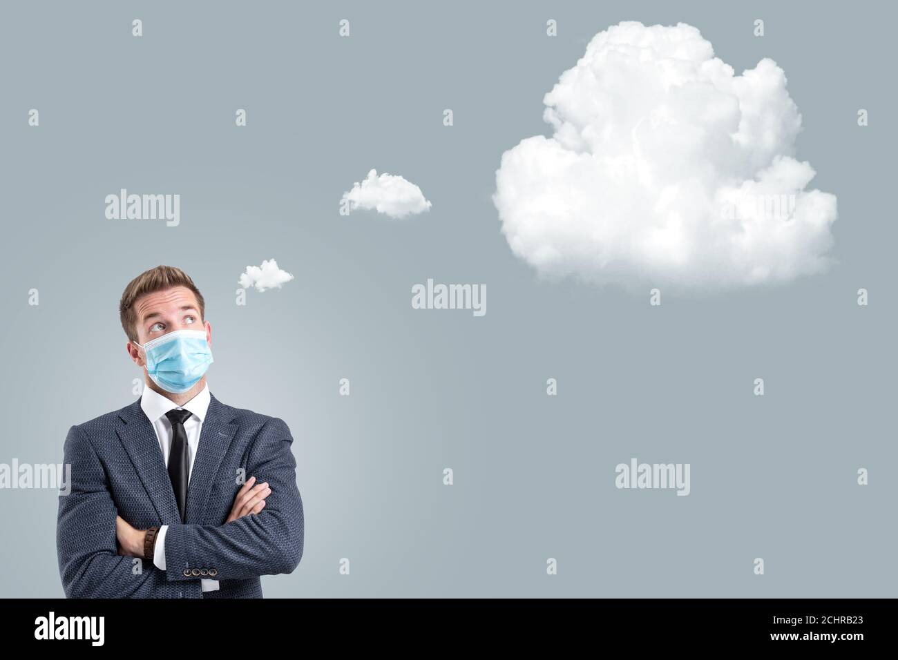 Businessman with a face mask next to a thought bubble Stock Photo