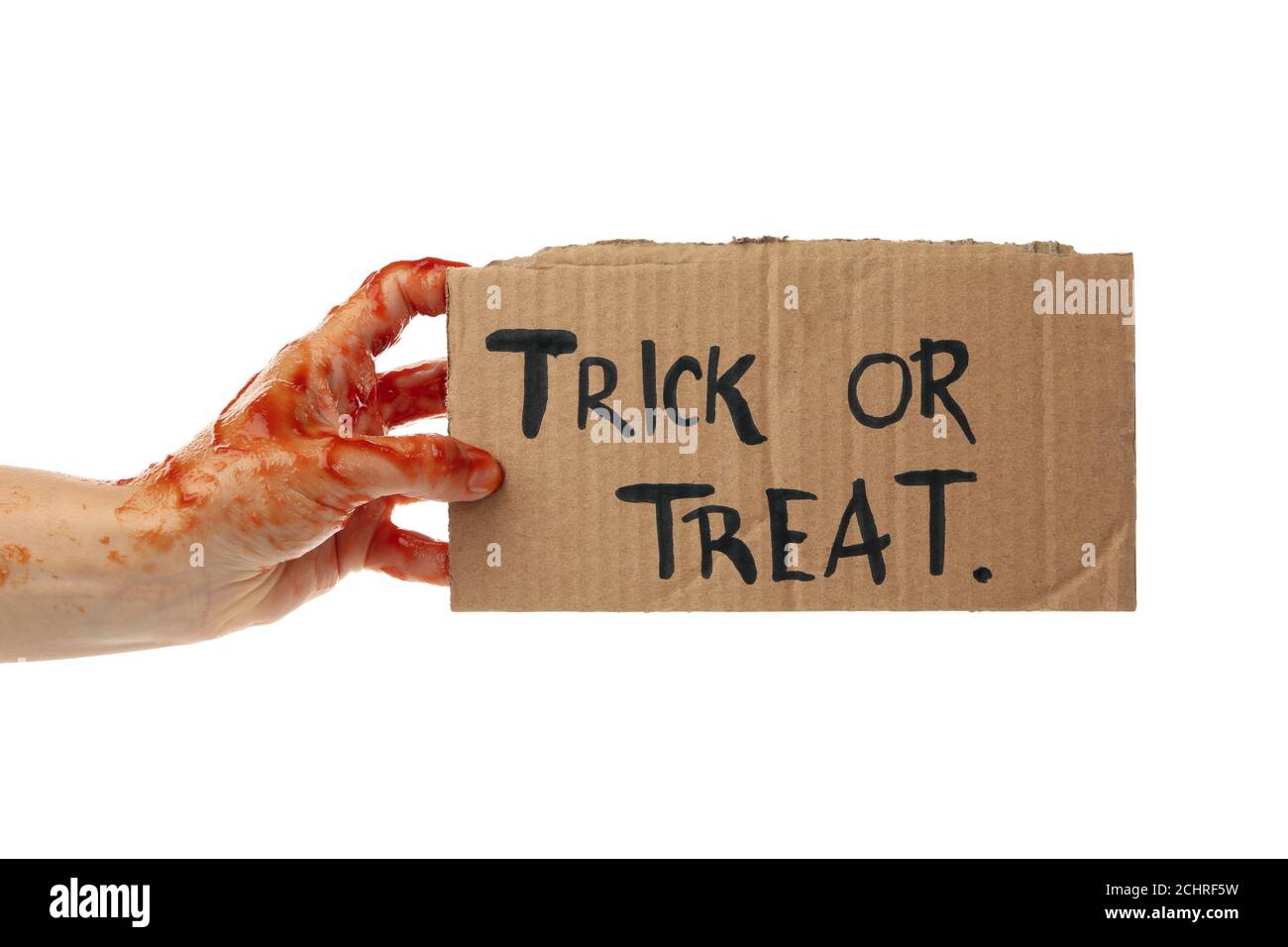 Zombie hand hold carton with text Trick or treat, isolated on white background Stock Photo