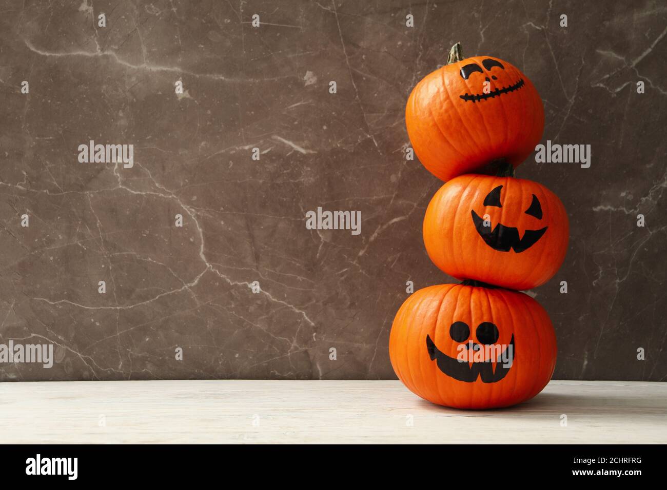 Funny halloween pumpkins against gray background, space for text Stock Photo