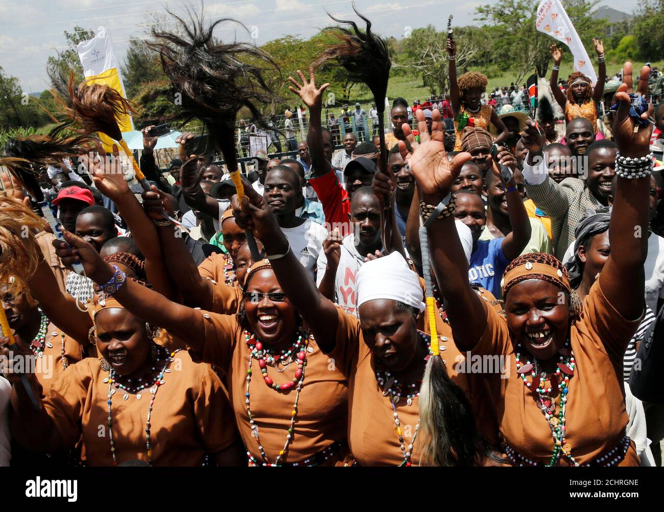Residents cheer at a train along the Standard Gauge Railway (SGR) line constructed by the China Road and Bridge Corporation (CRBC) and financed by Chinese government in the outskirts of Rongai, Kenya October 16, 2019. REUTERS/Thomas Mukoya Stock Photo