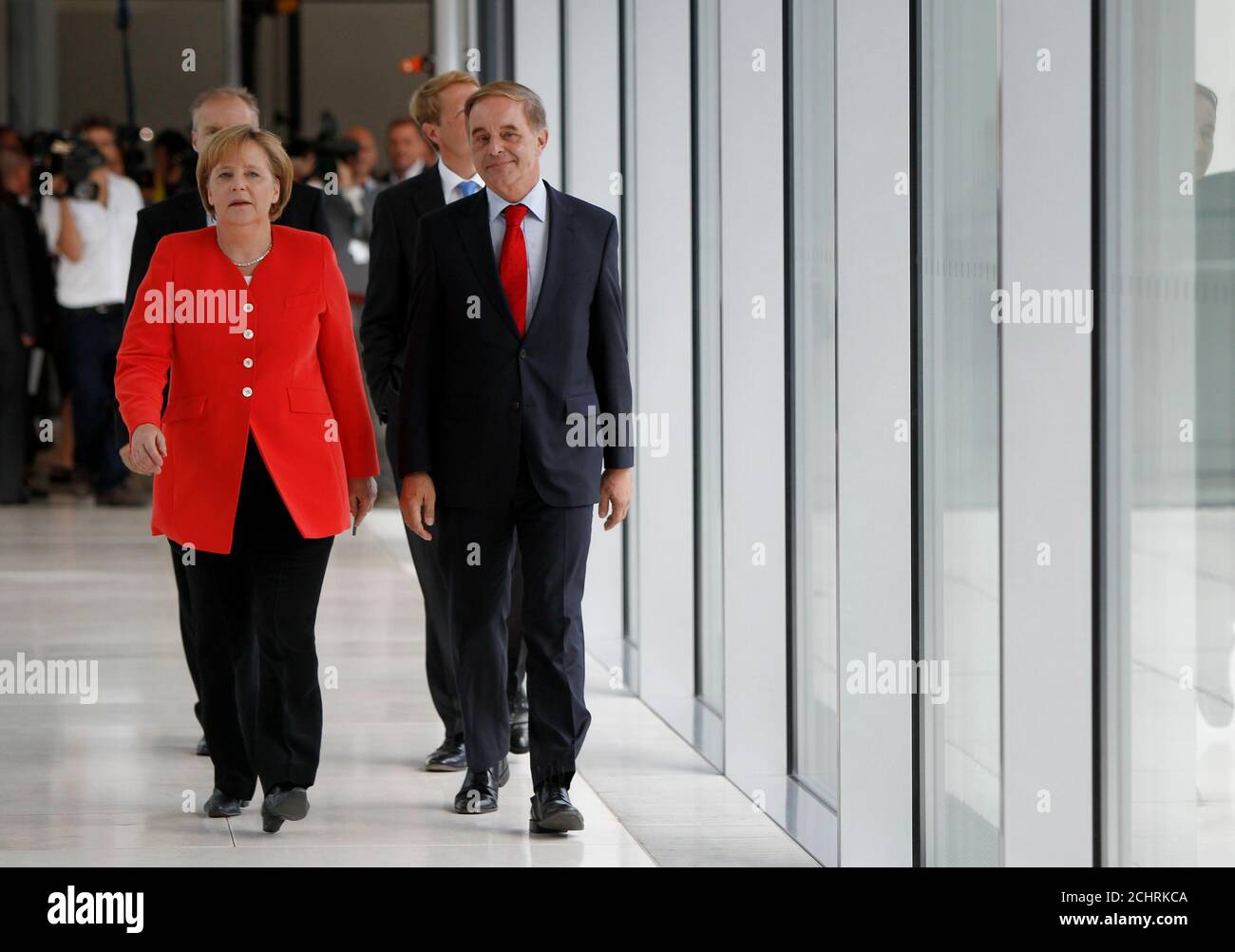 German Chancellor and head of the Christian Democratic Union (CDU) Angela Merkel (L) arrives with Joerg van Essen of the liberal Free Democratic Party (FDP) to join a FDP parliamentary group meeting in Berlin, July 6, 2010. REUTERS/Thomas Peter  (GERMANY - Tags: POLITICS) Stock Photo