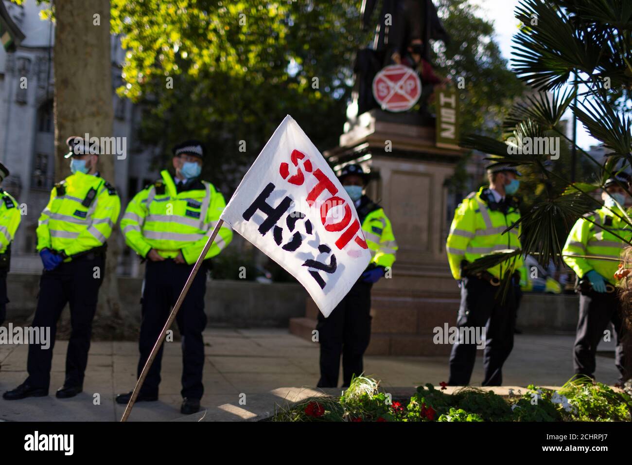 A protest flag and police during HS2 Rebellion tree occupation, Parliament Square, London, 5 September 2020 Stock Photo