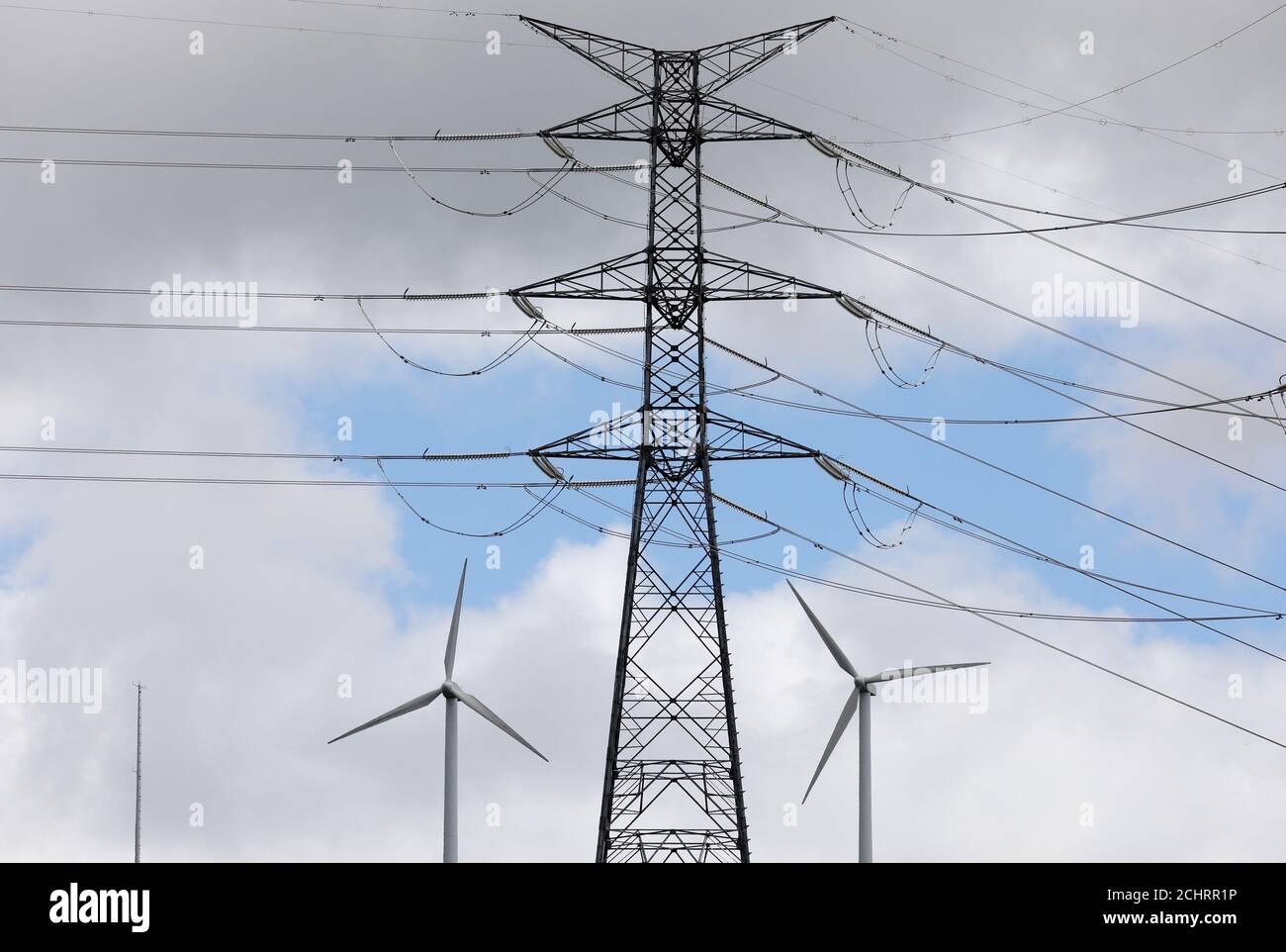 Wind Turbines Used To Generate Electricity Are Seen Underneath An Electricity Pylon In El Palo Summit Near Pola De Allande Northern Spain August 9 17 Reuters Paul Hanna Stock Photo Alamy