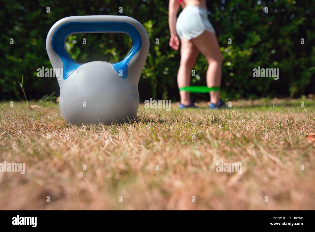 Fitness kettlebell woman cross training outside on crass lifting