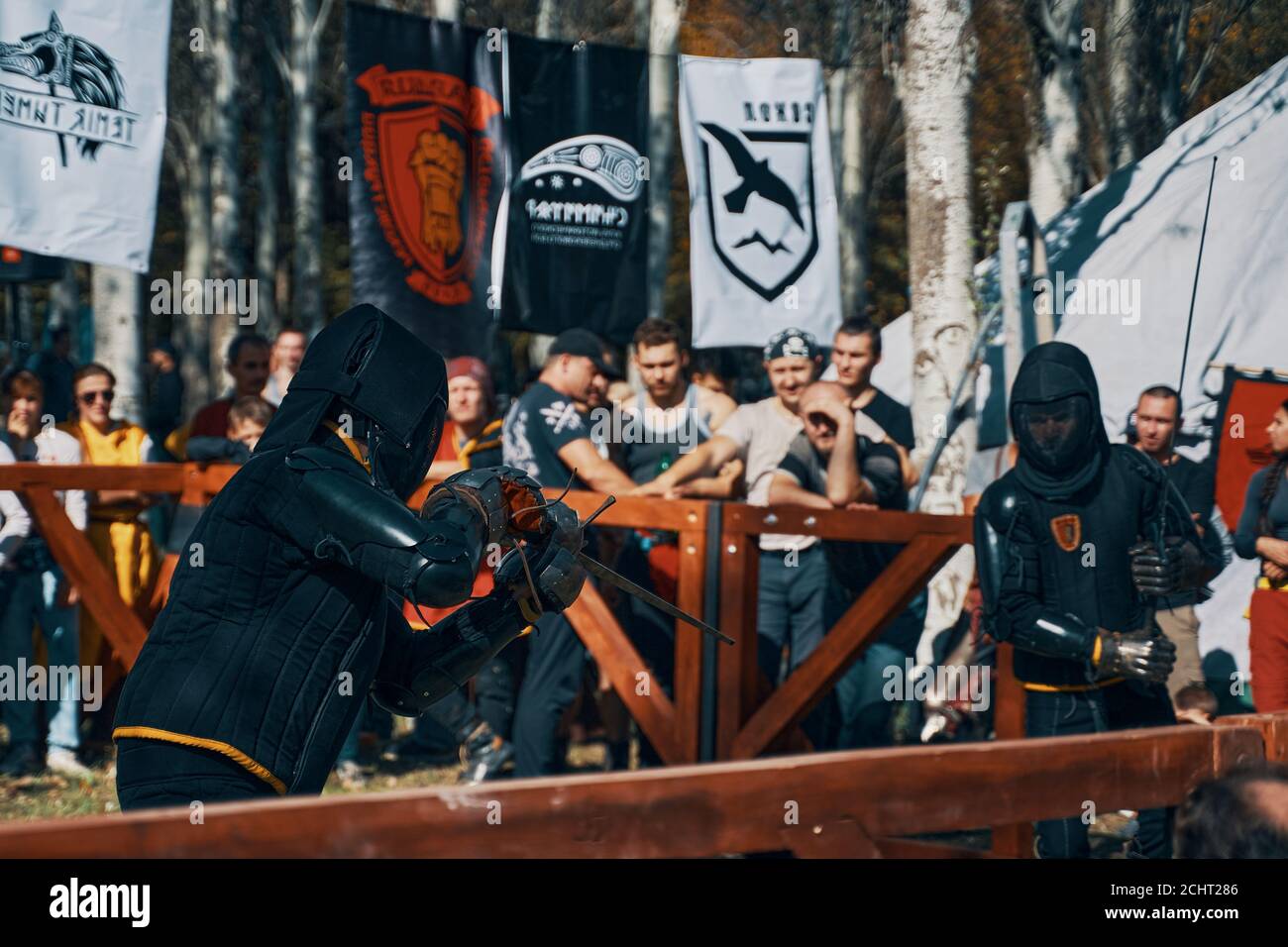 Battle of two knights with swords. Spectators and banners of historical ...