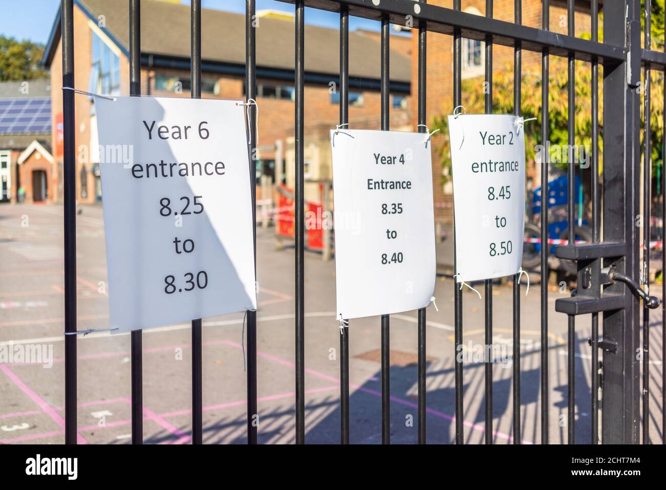 Southampton, UK. 14 September 2020. Covid-19 notice social distancing safeguarding, staggered entrance time slots for school children separated by year, signs at a fence near the entrance to the Freemantle Community Primary School in Southampton, Hampshire, England, UK Stock Photo