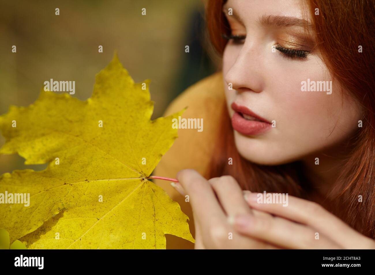 woman with yellow maple leaves in autumn Stock Photo