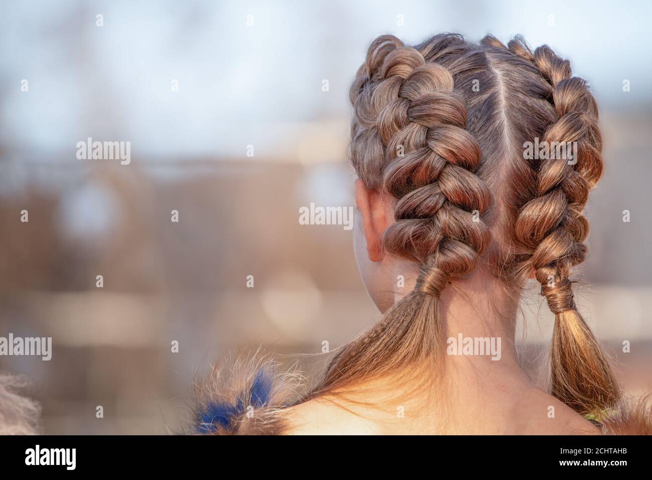 Hairstyle French braid inside out, on the head of a young girl. Stock Photo