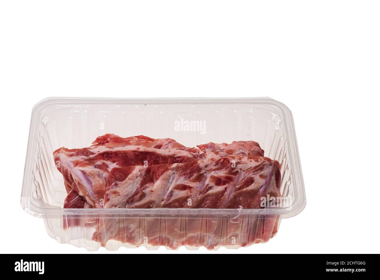 Close up view of raw pork ribs in plastic container isolated on ...