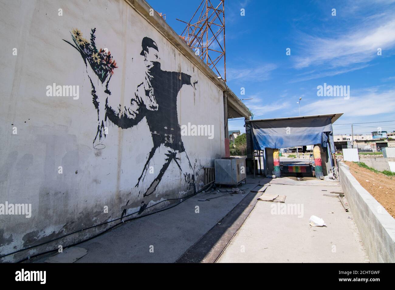 Banksy's famous mural  'Rage, The Flower Thrower (Love Is In The Air)' which is painted on a car wash in a suburb of Betlehem (Palestine) Stock Photo