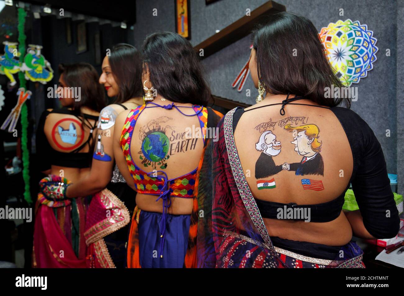 Women pose after they got body paint tattoos sketched on their backs in preparations for the upcoming Navratri, a festival when devotees worship the Hindu goddess Durga in Ahmedabad, India, September 24, Women pose after they got body paint tattoos sketched on their backs in preparations for the upcoming Navratri, a festival when devotees worship the Hindu goddess Durga in Ahmedabad, India, September 24,