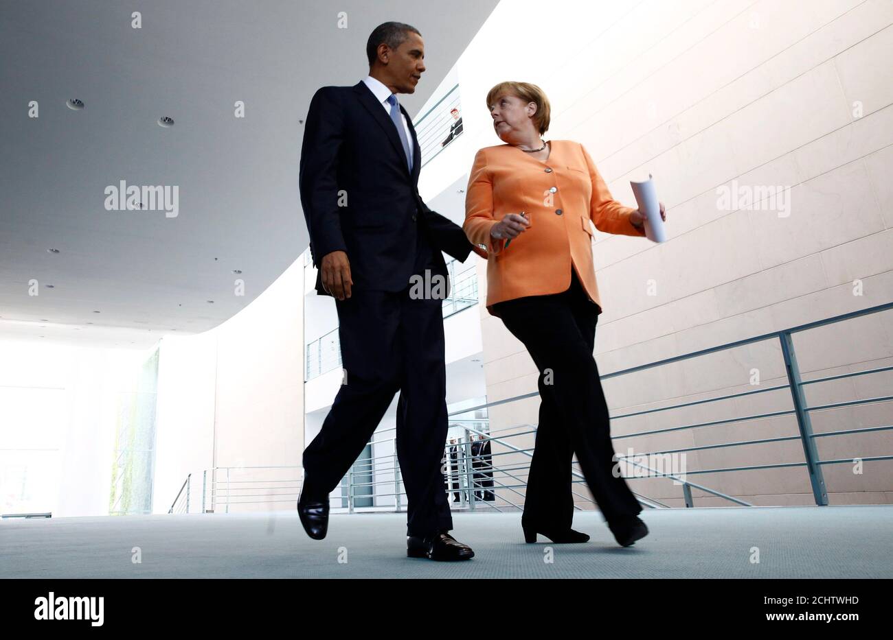 U.S. President Barack Obama and German Chancellor Angela Merkel (R) make their way to a news conference at the Chancellery in Berlin June 19, 2013. Obama will unveil plans for a sharp reduction in nuclear warheads in a landmark speech at the Brandenburg Gate on Wednesday that comes 50 years after John F. Kennedy declared 'Ich bin ein Berliner' in a defiant Cold War address.              REUTERS/Thomas Peter (GERMANY  - Tags: POLITICS) Stock Photo