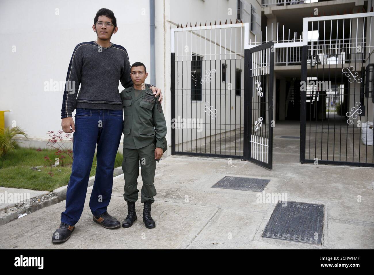 Jeison Rodriguez L 19 The Living Person With The Largest Feet In The World Poses For A Picture With His Older Brother Wilmer 24 Outside Their House In Maracay Venezuela October 14