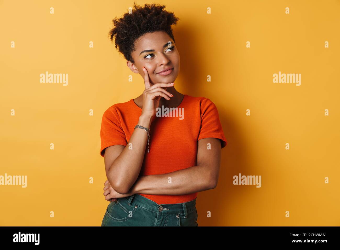 Image of pleased african american woman thinking and looking upward ...