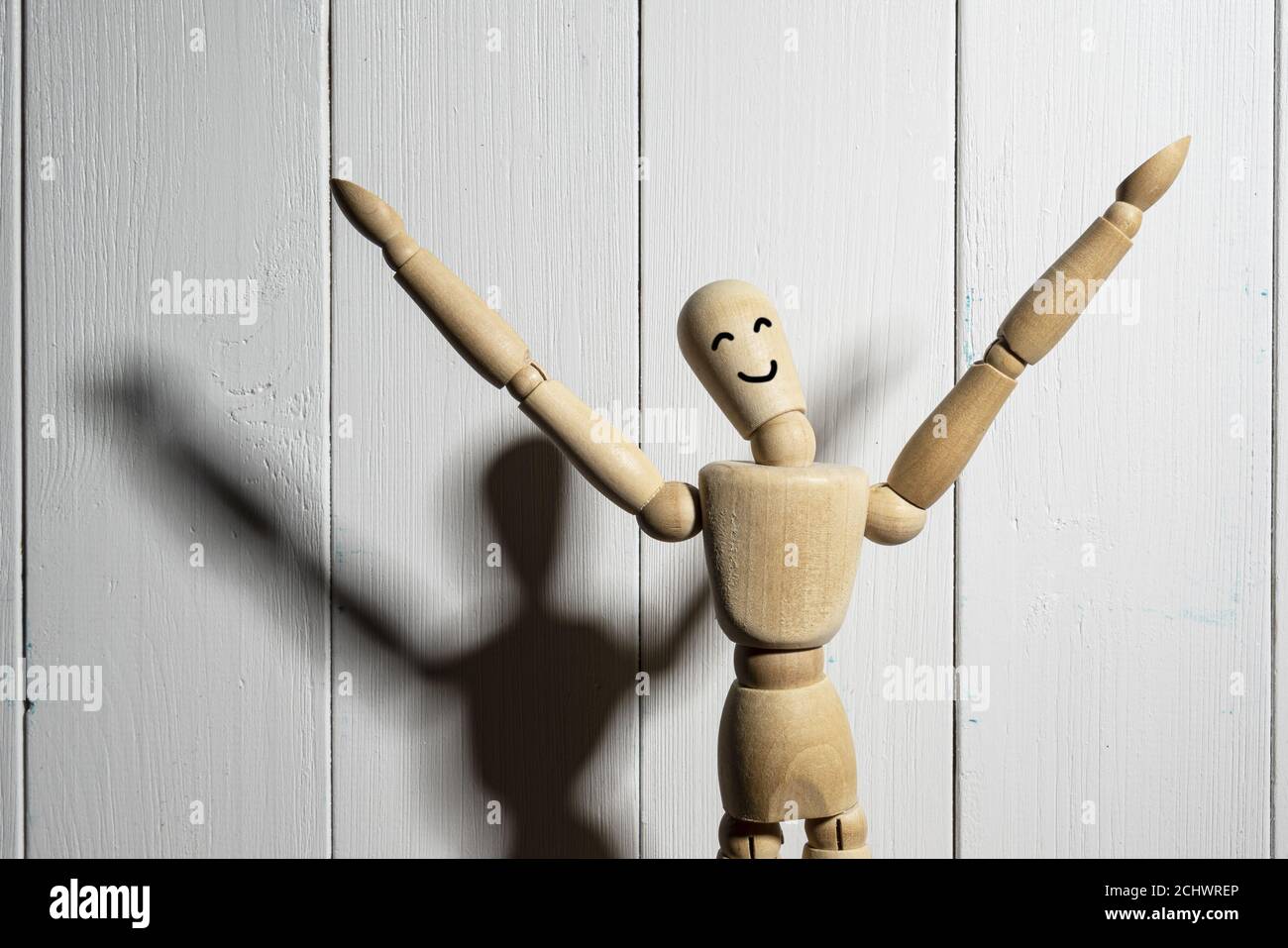 wooden mannequin sitting on black background in horizontal profile Stock  Photo