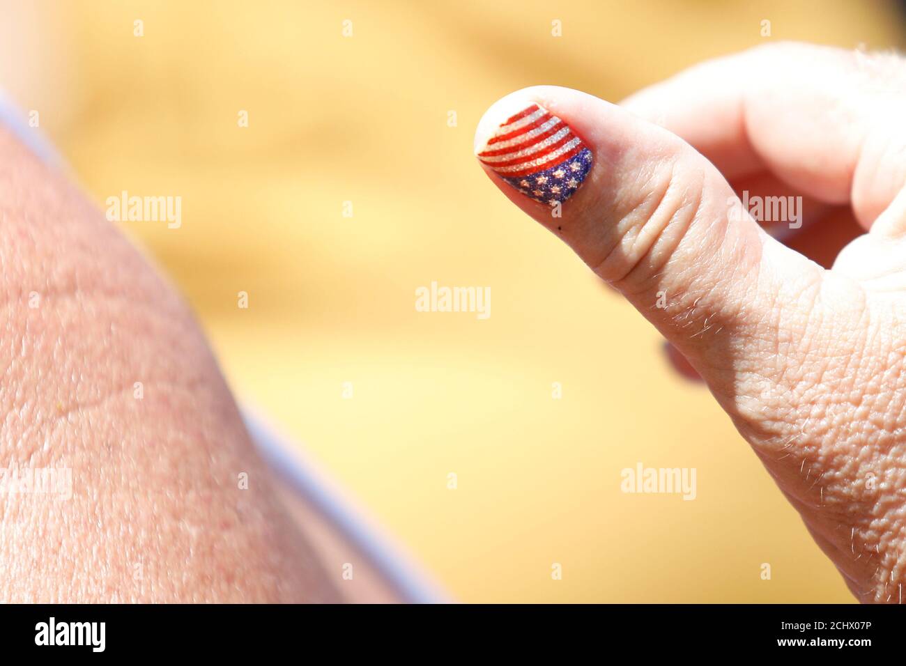 A Pro-Trump demonstrator holds up her custom designed American flag finger nail  design during a conservative activist demonstration along Pennsylvania  Avenue outside the White House in Washington, U.S., July 3, 2019.  REUTERS/Tom