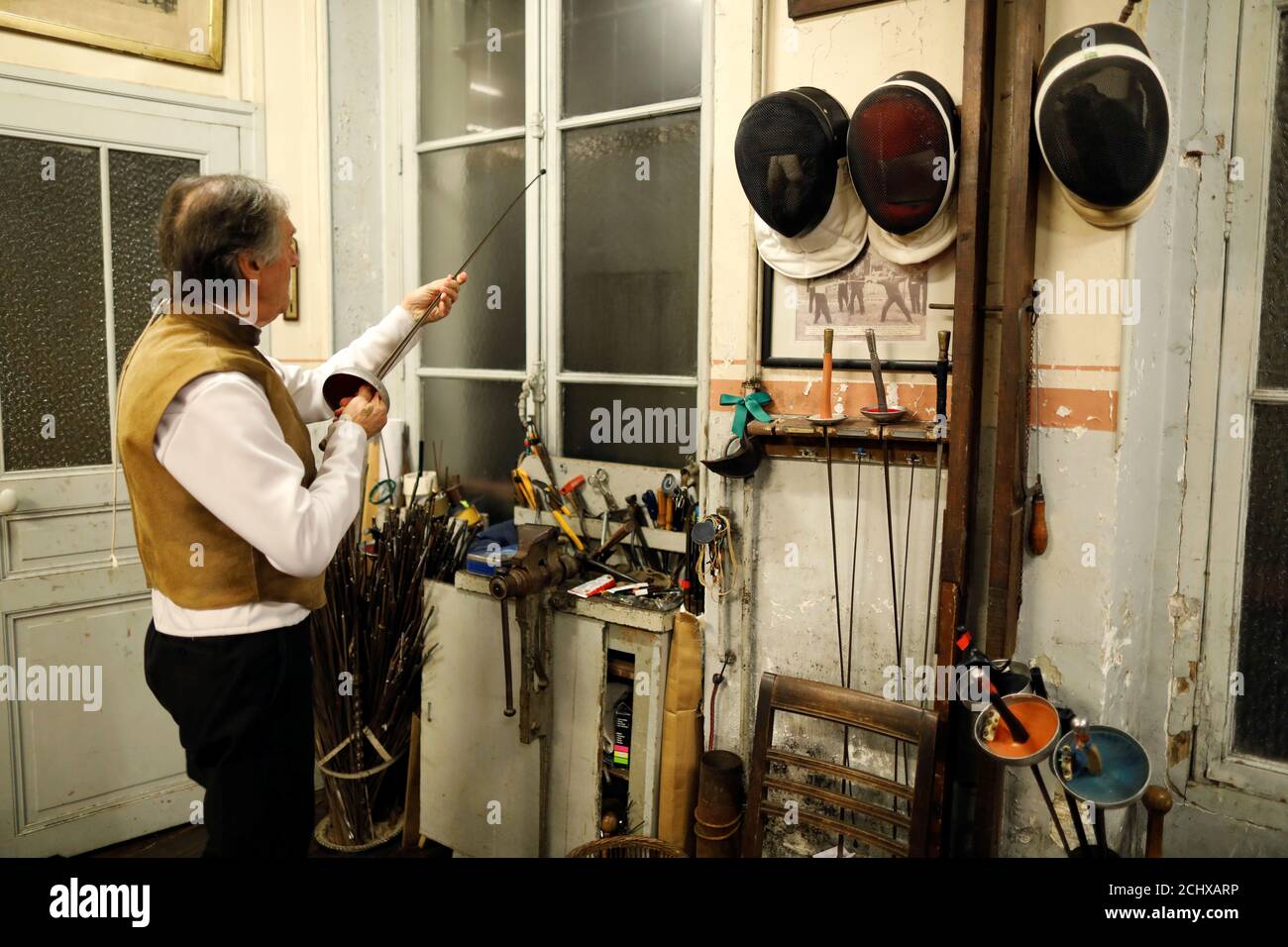Master Jean-Pierre Pinel La Taule fixes an epee at the Salle d'Armes  Coudurier in the Quartier Latin in central Paris, France, January 28, 2019.  This oldest fencing club in Paris, founded in