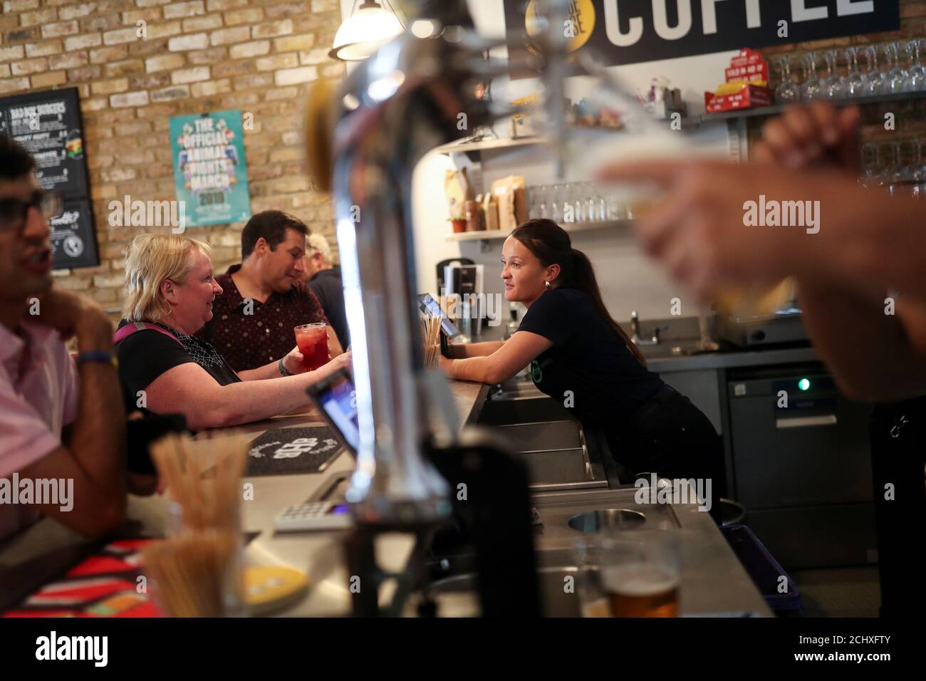 Customers are served at the Green Vic, which is aiming to be the world's most ethical pub, in Shoreditch, London, Britain July 5, 2019. Picture taken July 5, 2019. REUTERS/Simon Dawson Stock Photo