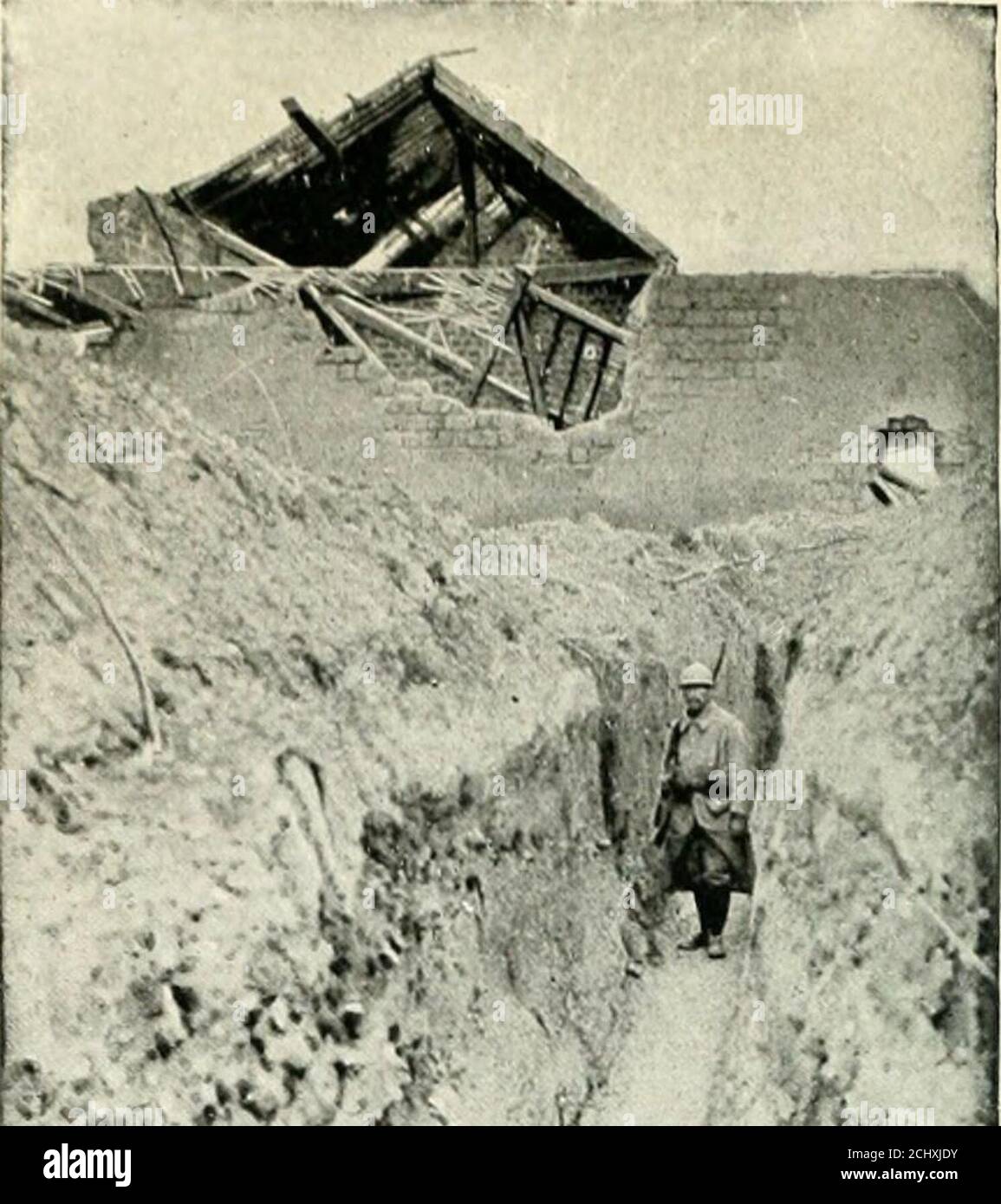 . Rheims and the battles for its possession . THE BUTTE-DE-TIR SECTORListening-post in front of Cernay village. 108. J? v &gt;* •.. COMMUNICATING TRENCH AT JOUISSANCE FARM (1915) The road crosses the Chalons Railway {I. c.), and goes thence direct to theFort of La Pompelle, passing through an inextricable network of trenchesand barbed wire entanglements. The country hereabouts was completelyravaged by the terriffic bombardments, and recalls the devastated regionsaround Verdun, near Vaux and Douaumont (see the Michelin Illustrated Guide:Verdun, and the Battles for its Possession). La Jouissance Stock Photo