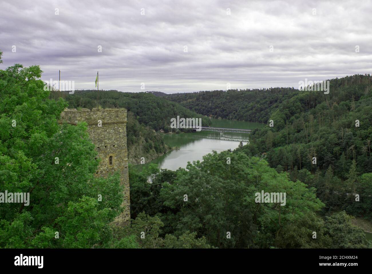 View from the Bitov castle on the water level in which the reflection of the trees, in the background is a bridge, in the foreground is tower Stock Photo