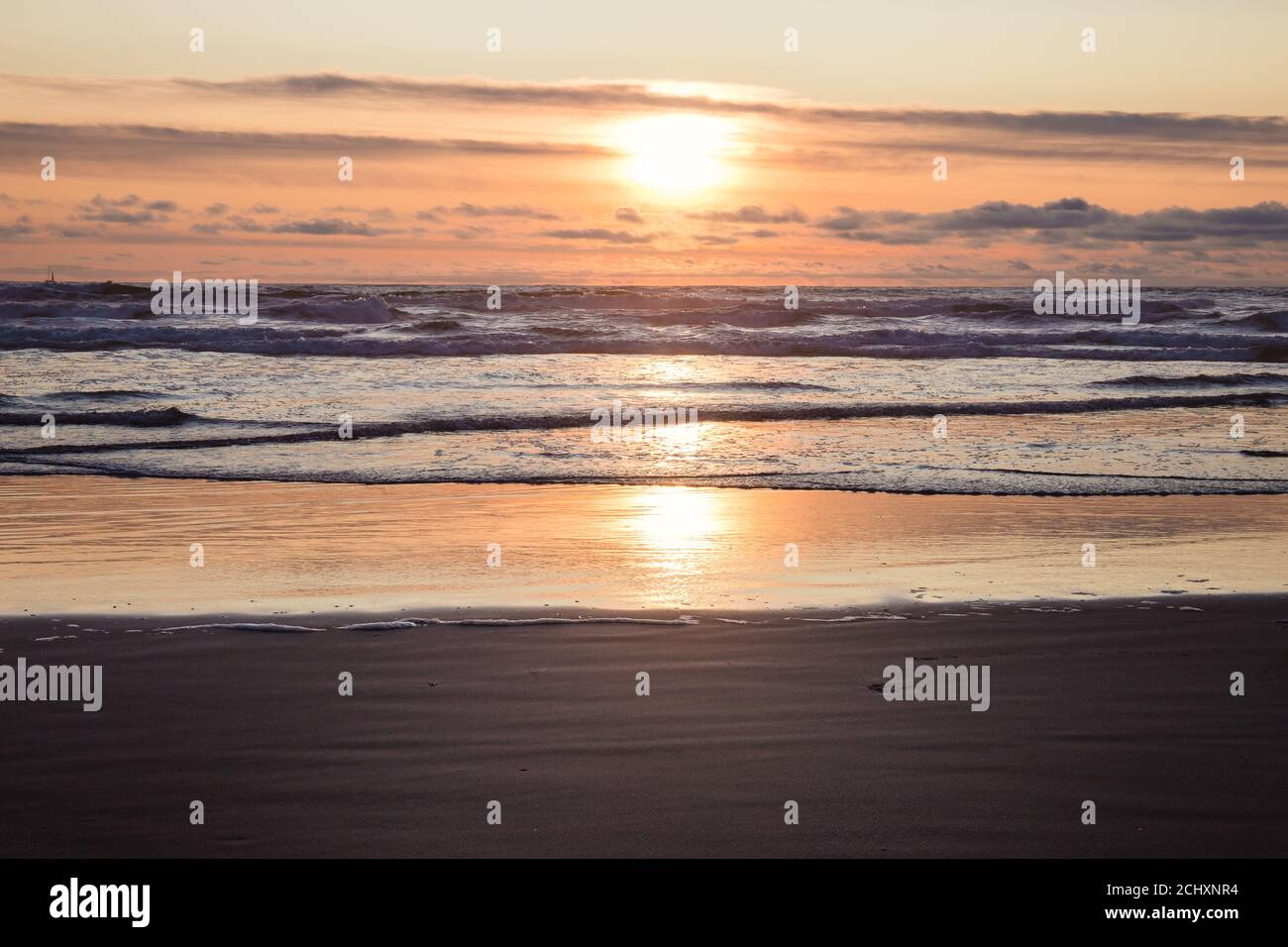 Reflection of Orange Sunset on Ocean Beach Stock Photo