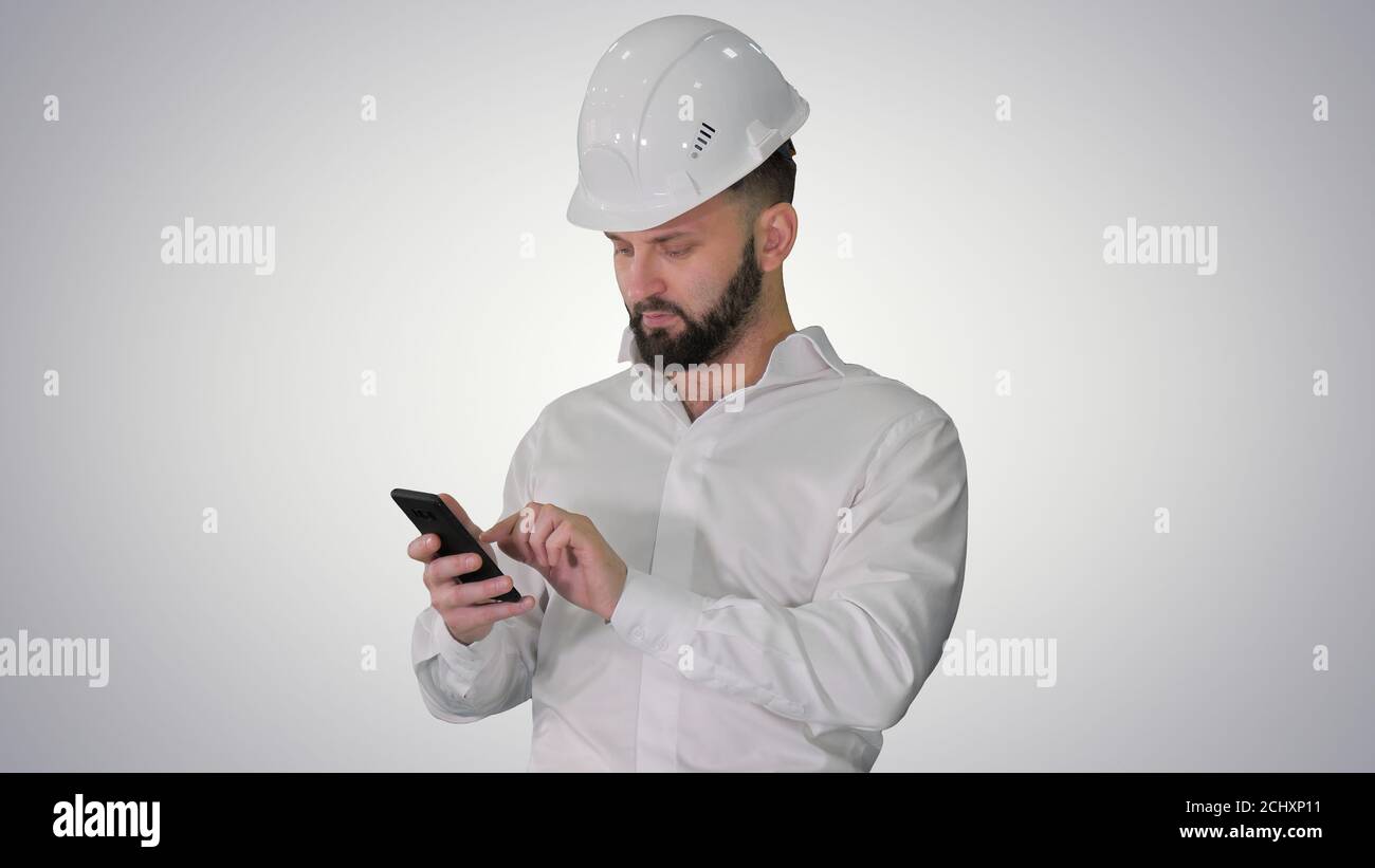 Smart engineer in white shirt and safety engineering hat using s Stock Photo