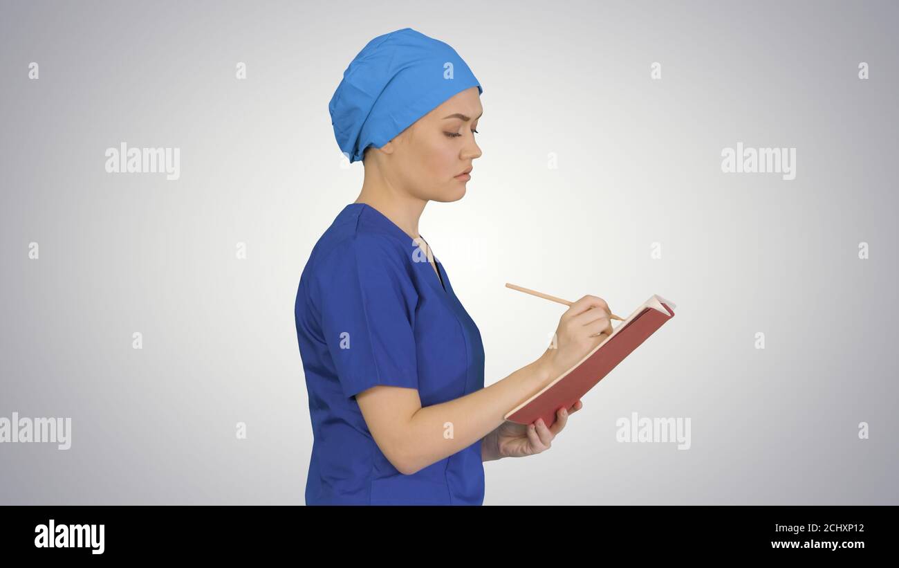 Female professional doctor hand making notes in medical journal Stock Photo