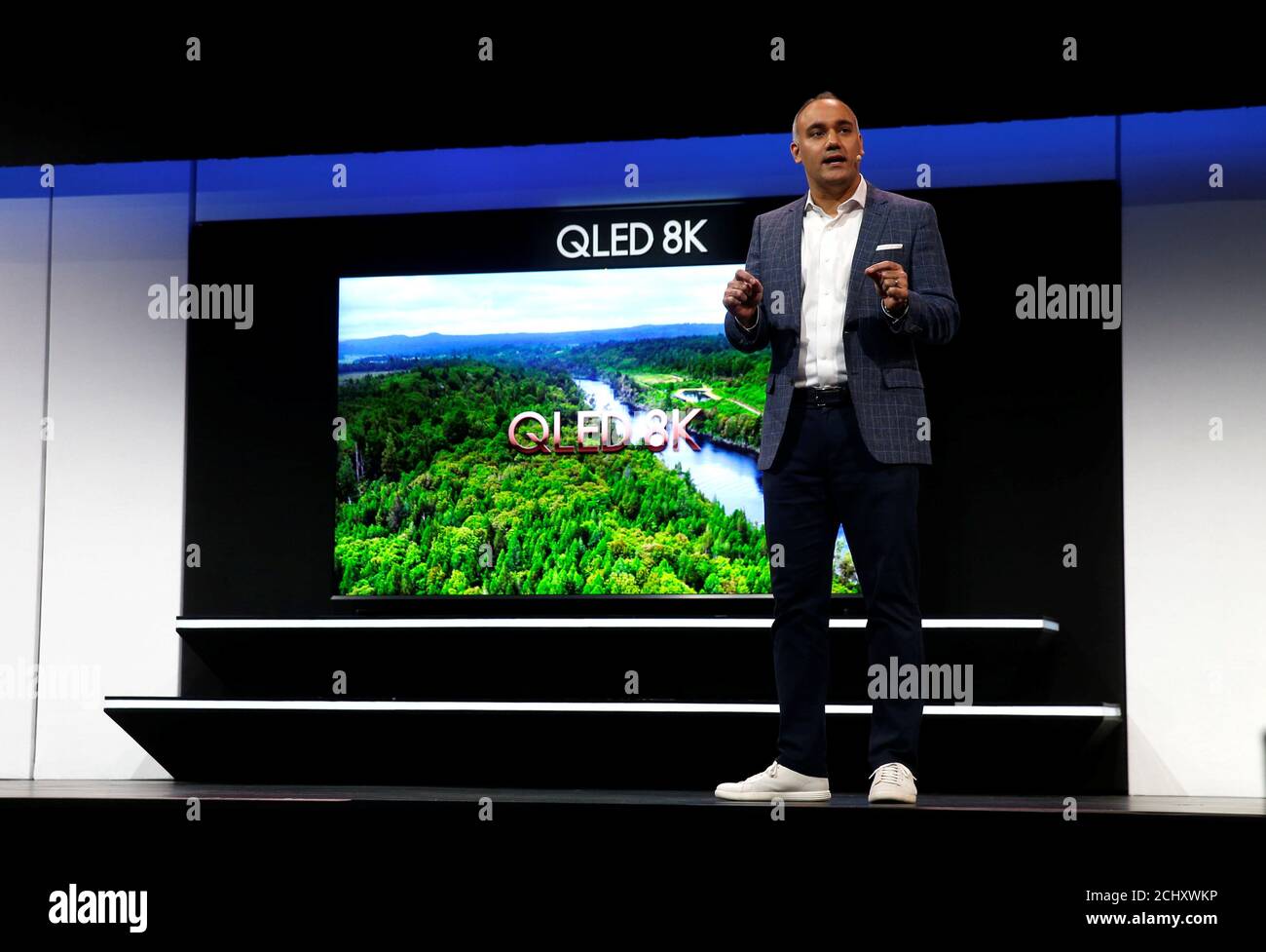 Dave Das, senior vice president of consumer electronics product marketing at Samsung Electronics America, speaks by a 98-inch, QLED 8K smart television during a Samsung news conference at the 2019 CES in Las Vegas, Nevada, U.S. January 7, 2019. REUTERS/Steve Marcus Stock Photo