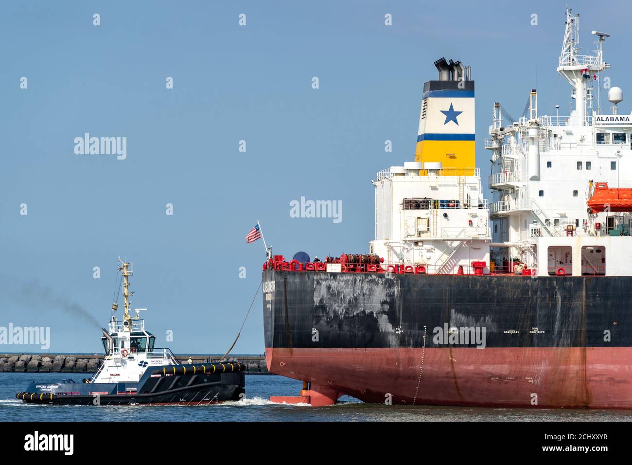 Tugboat SVITZER JUPITER at work. Svitzer is the global leader of towage and marine services and part of the A.P. Moller-Maersk Group. Stock Photo