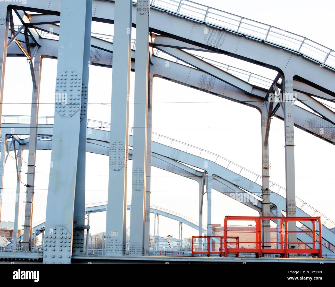 landscape with railway with trains, lot of steel rafters at sunset ...