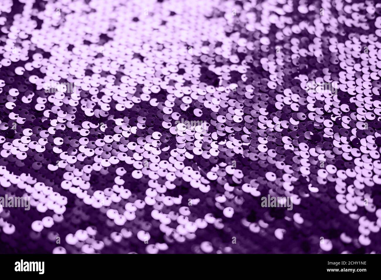 Sequin fabric texture. Shiny silver sparkling background. Clothing piece of glitter metallic for a glamorous party, celebration. Close-up. Toned image Stock Photo