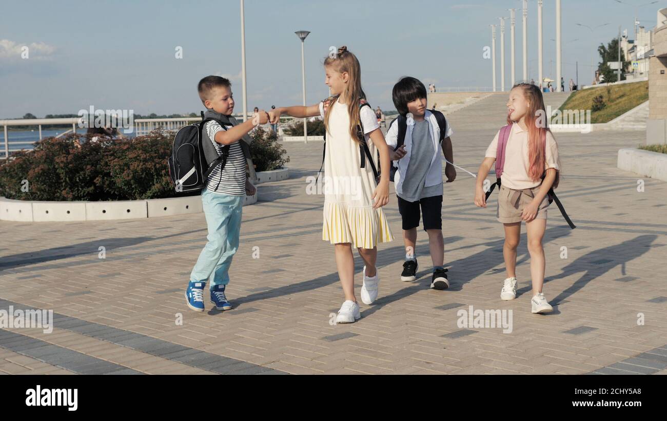 Four Friends Are Going to School. Stock Photo