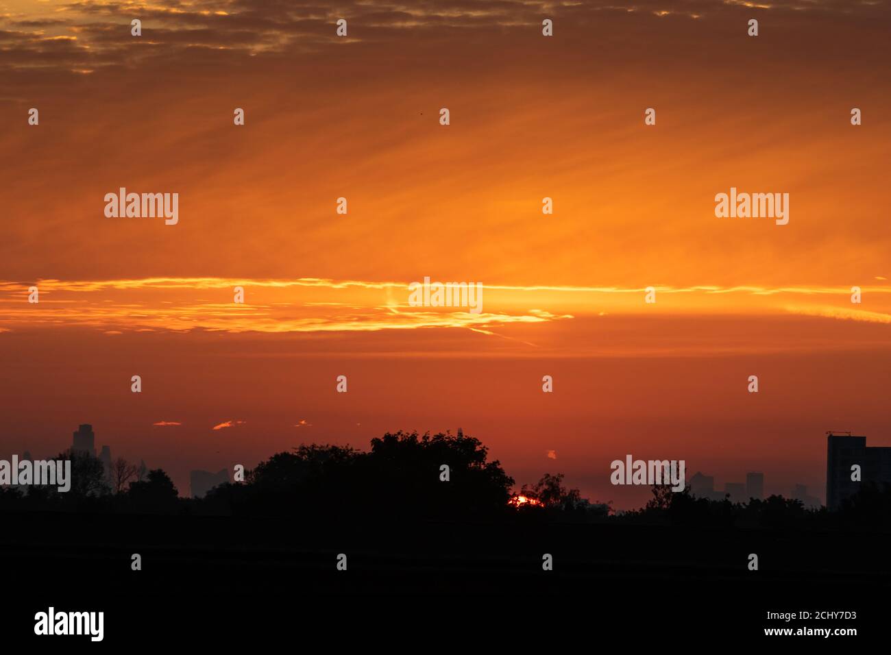 A colourful sunrise over the rooftops of west London Stock Photo Alamy