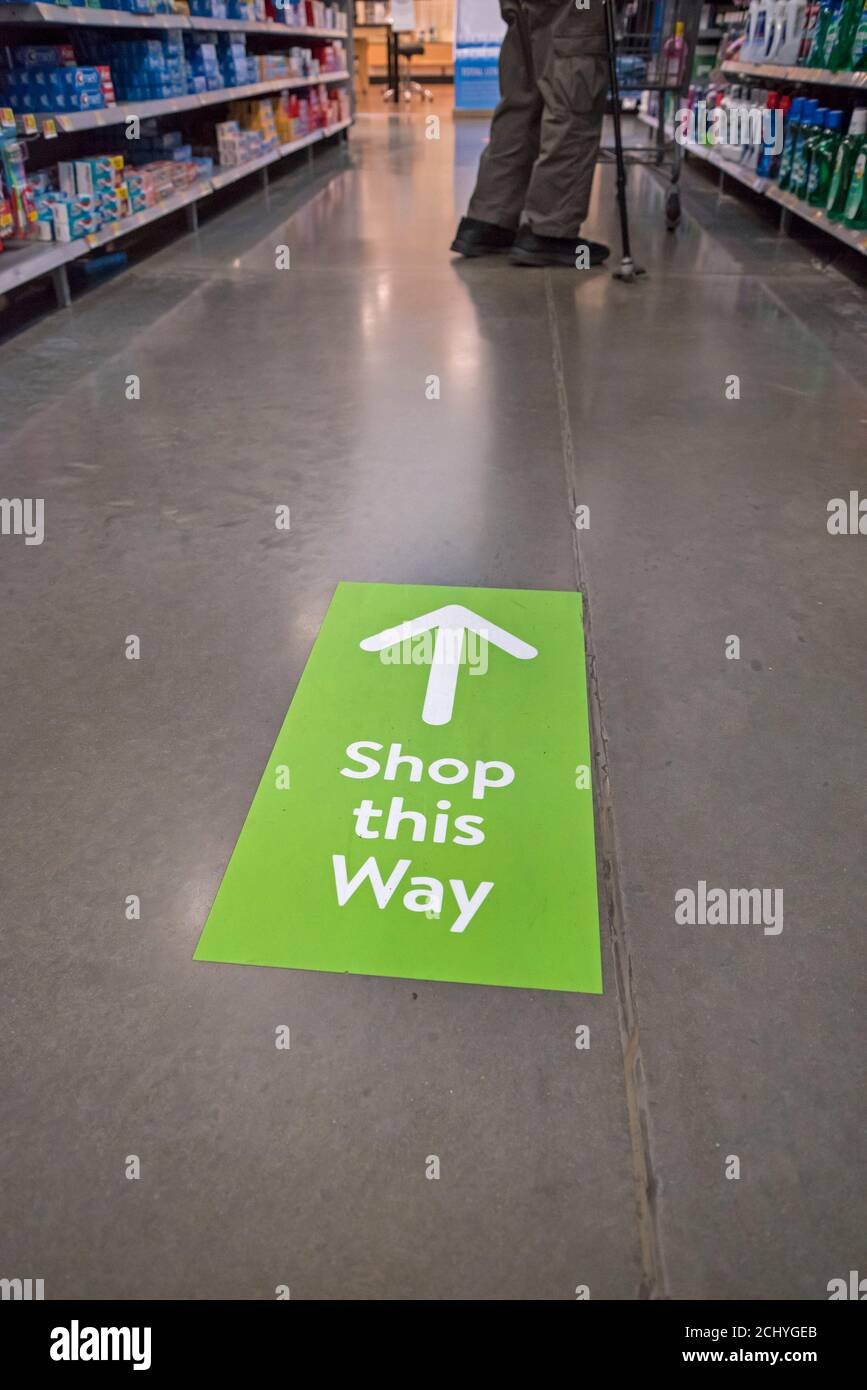 Covid 19 directional shopping signs inside store. Stock Photo