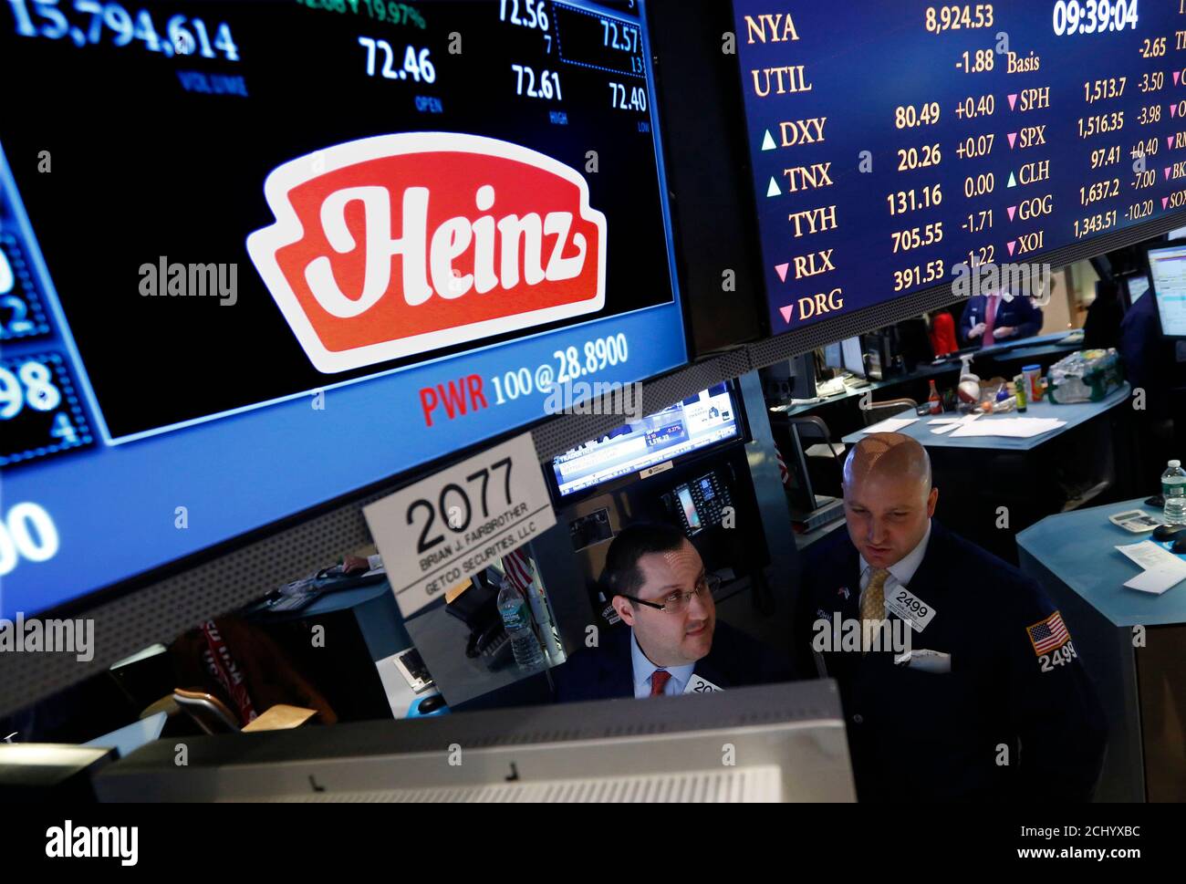 Traders work at the post that trades H.J. Heinz Co. on the floor of the New York Stock Exchange, February 14, 2013. Warren Buffett's Berkshire Hathaway and private equity firm 3G Capital will buy ketchup and baby food maker H.J. Heinz Co for $23.2 billion in cash, a deal that combines 3G's ambitions in the food industry with Buffett's hunt for growth. REUTERS/Brendan McDermid (UNITED STATES - Tags: BUSINESS FOOD) Stock Photo
