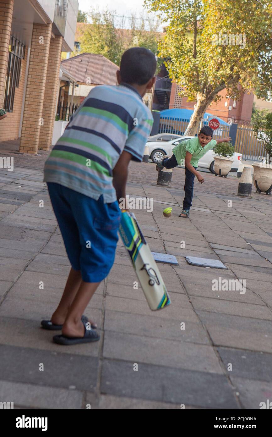 Young indian boys playing cricket in Fordsburg, Johannesburg, South Africa Stock Photo
