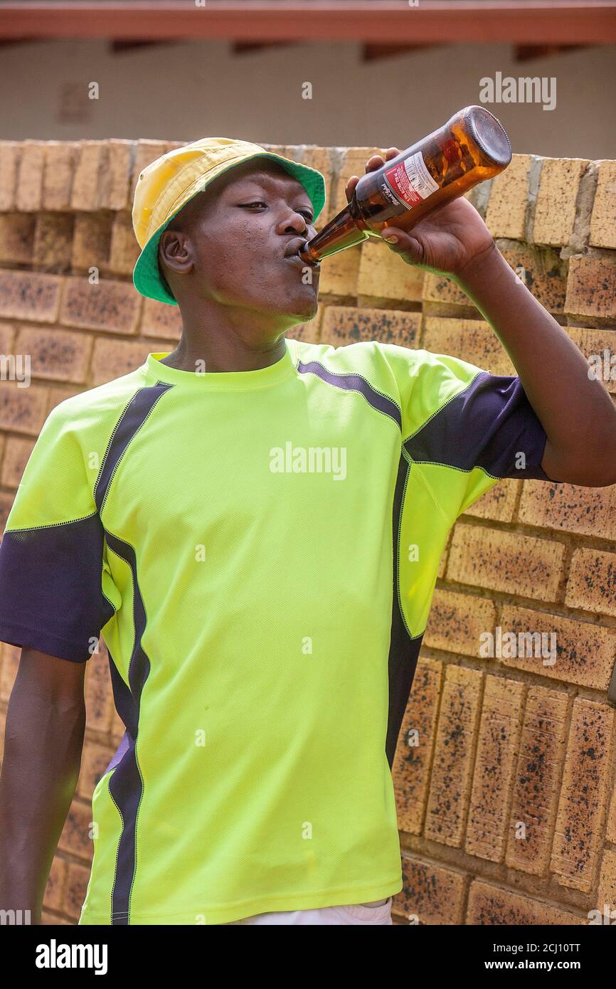 African man drinking alcohol in Soweto township, Johannesburg, South