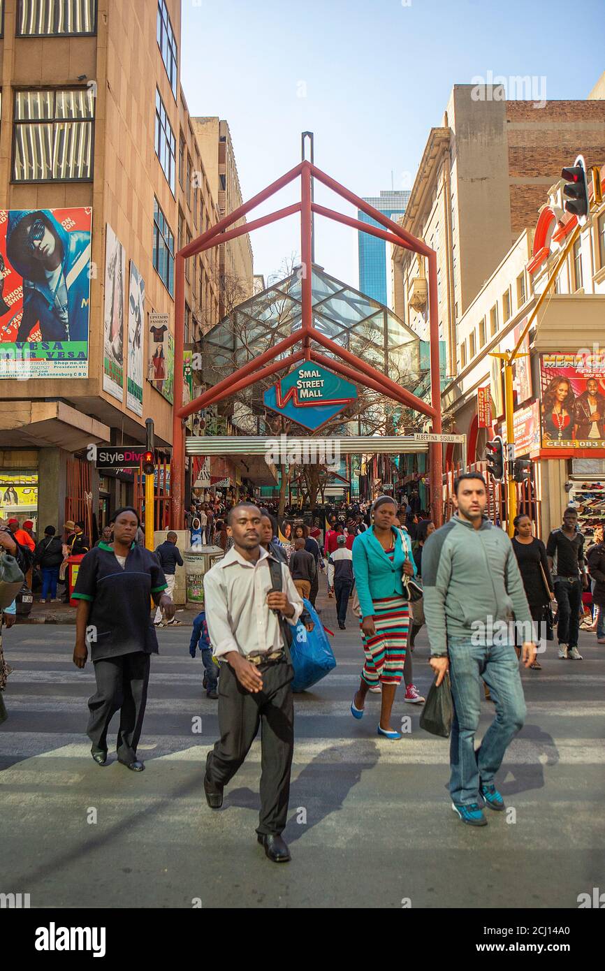 Crowd of African people waliking in front of Smal Street Mall in